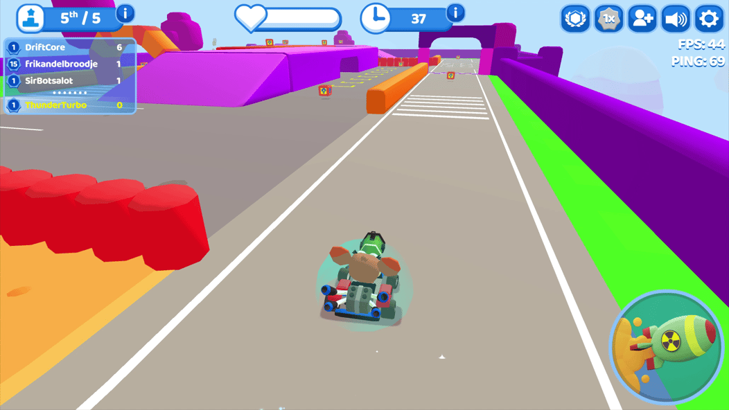 Smash Karts player driving along a colorful track toward weapon boxes and obstacles